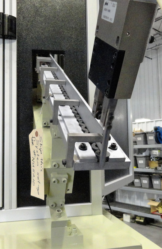 Down angle track with escapement